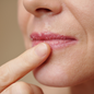 Woman applying sugar scrub to her lips